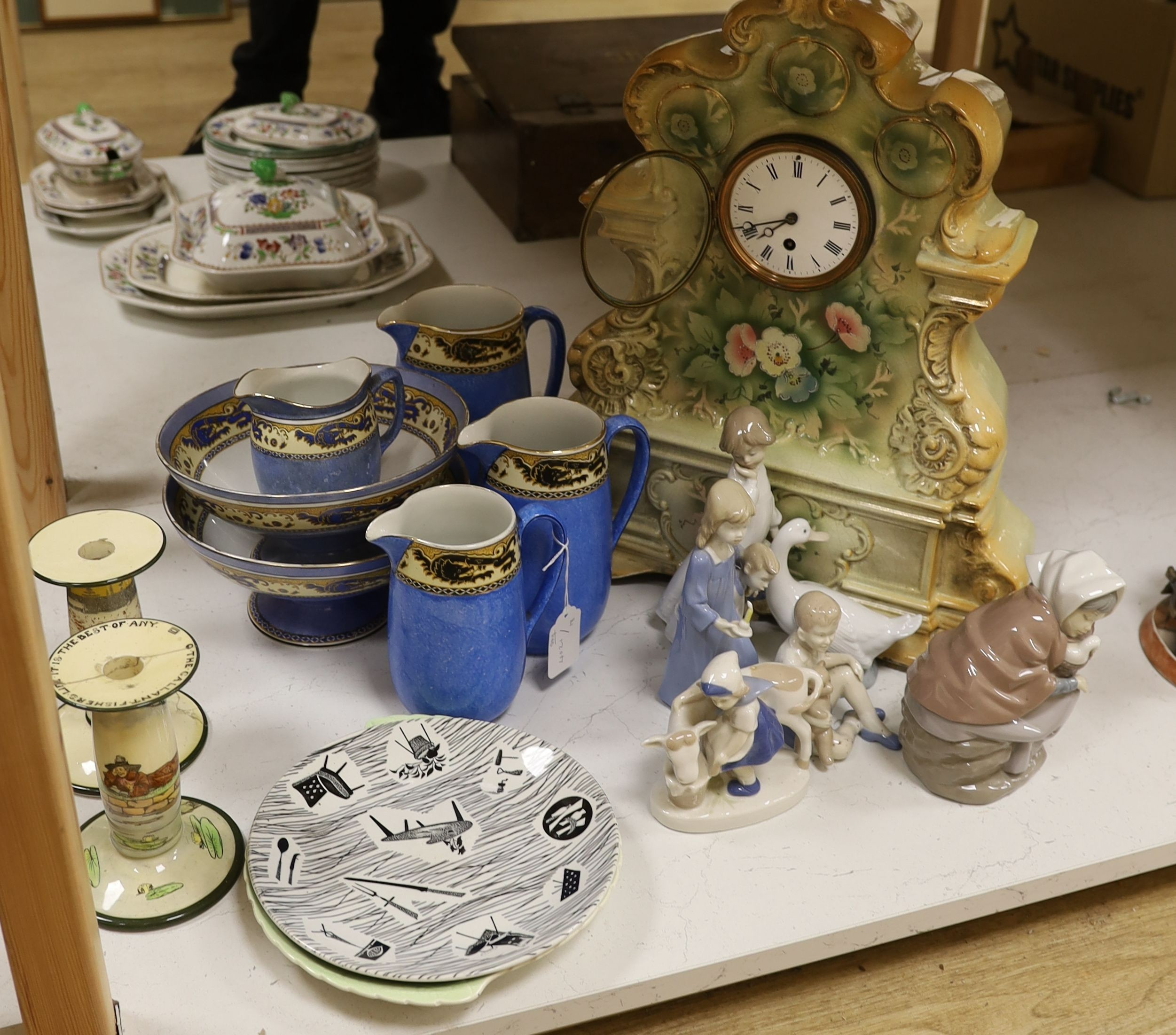 Six mixed Nao and other similar figures, a Homemaker plate, a Carltonware plate, four graduated jugs, and two pedestal bowls, a pair of mottoware candlesticks and a French china mantel clock